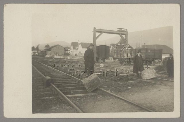 Zwei Männer mit Steinblöcken, die Schienen blockieren, Generalstreik 1918 beim Bahnhof Grenchen-Süd